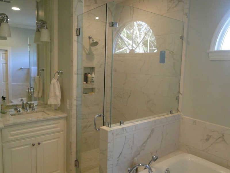 Remodeled bathroom with a glass-and-marble walk-in shower