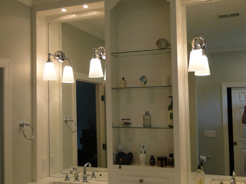 Bathroom vanity with a large mirror and built-in shelves
