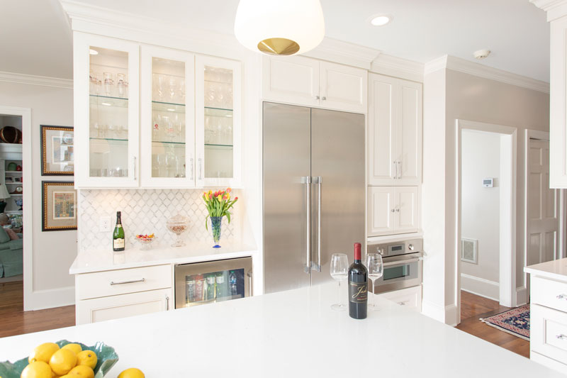 Remodeled kitchen with white cabinets and an island