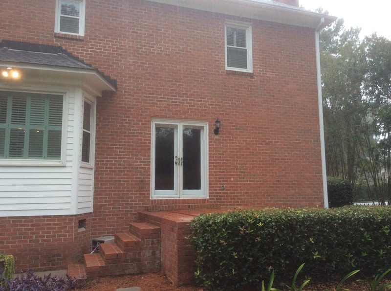 The back of a brick home before the screened porch was built