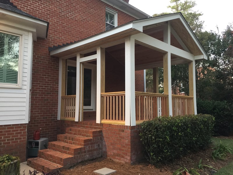 The porch further along with columns and roof in place