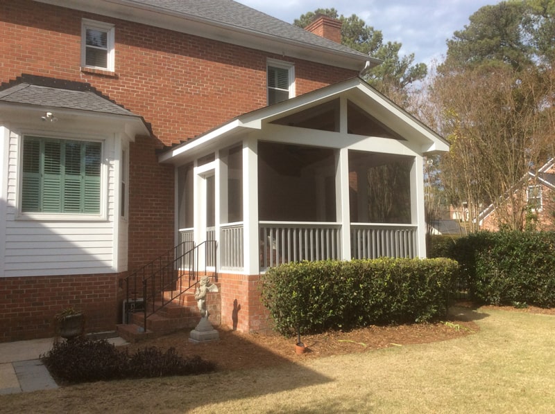 The finished screened porch with brick steps