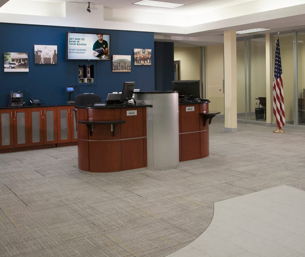 Remodeled commercial reception area with a wood desk and blue accent wall