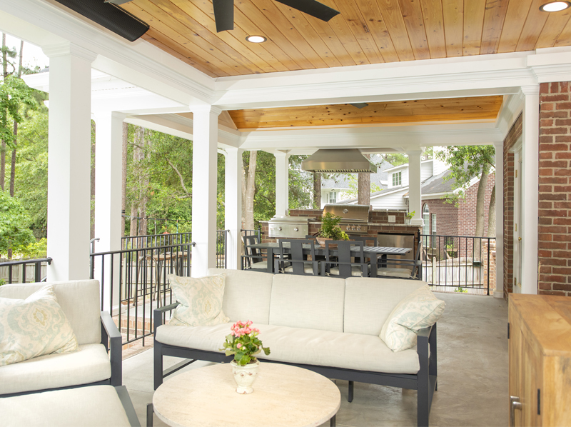 Covered porch with a wood-plank ceiling and outdoor seating