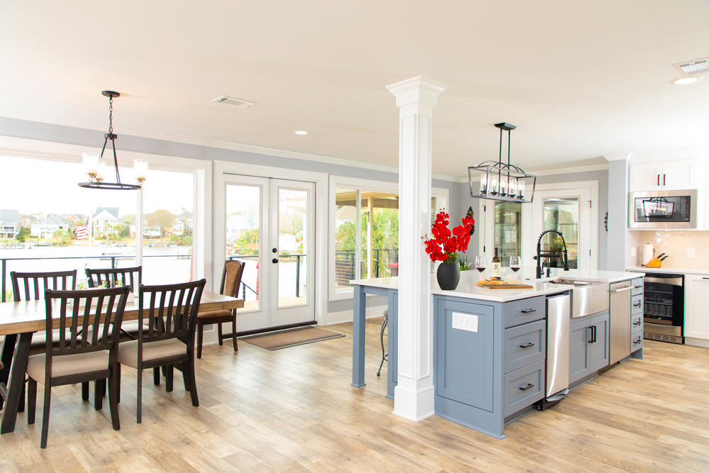 Open kitchen and dining renovation with a blue island and columns
